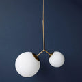Thumbnail photo of Two hanging lamp brass with two white glass shades